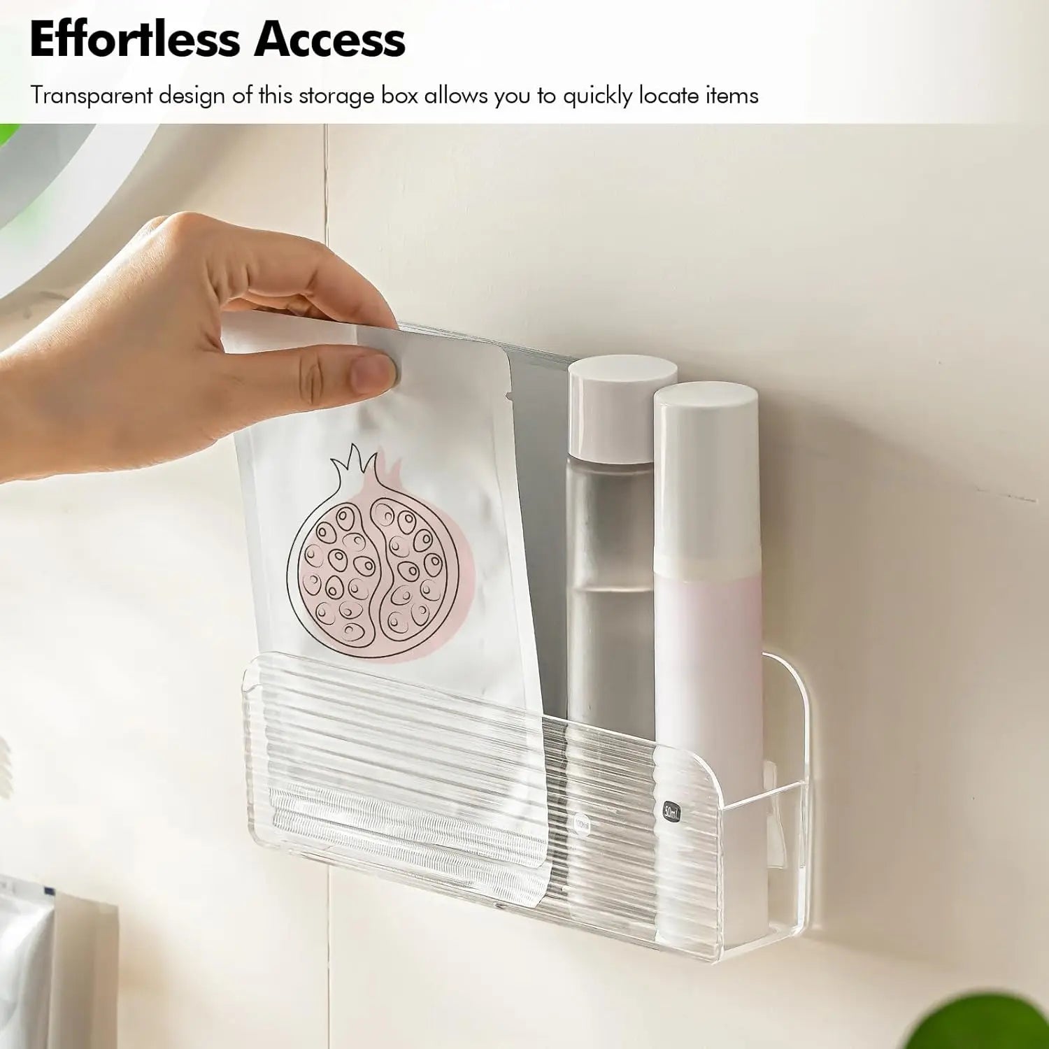 Hand placing a face mask pack into a clear wall-mounted storage bin in the bathroom