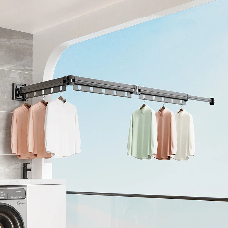 gunmetal wall-mounted folding drying rack installed on a balcony with shirts hanging