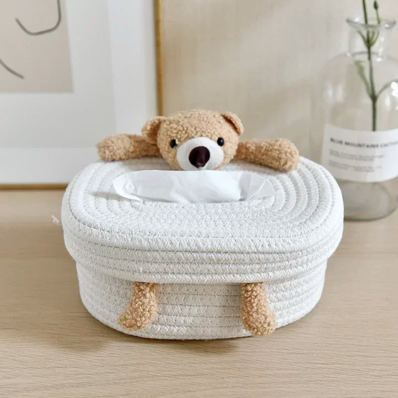 Close-up of plush bear tissue box cover on a table with tissue visible