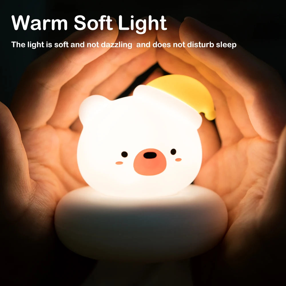 Bear shaped LED night light cupped in hands, showing warm diffused light