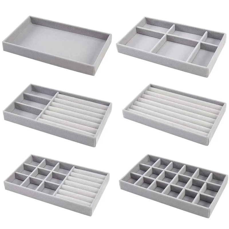 Six different styles of grey velvet jewelry organizer trays, shown empty for ring, earring, and accessory storage