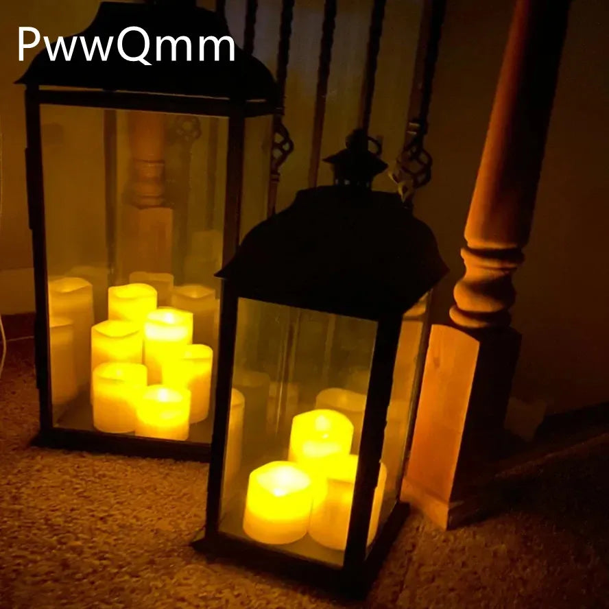 Multiple flameless LED pillar candles softly glowing inside black glass lanterns by a staircase at night