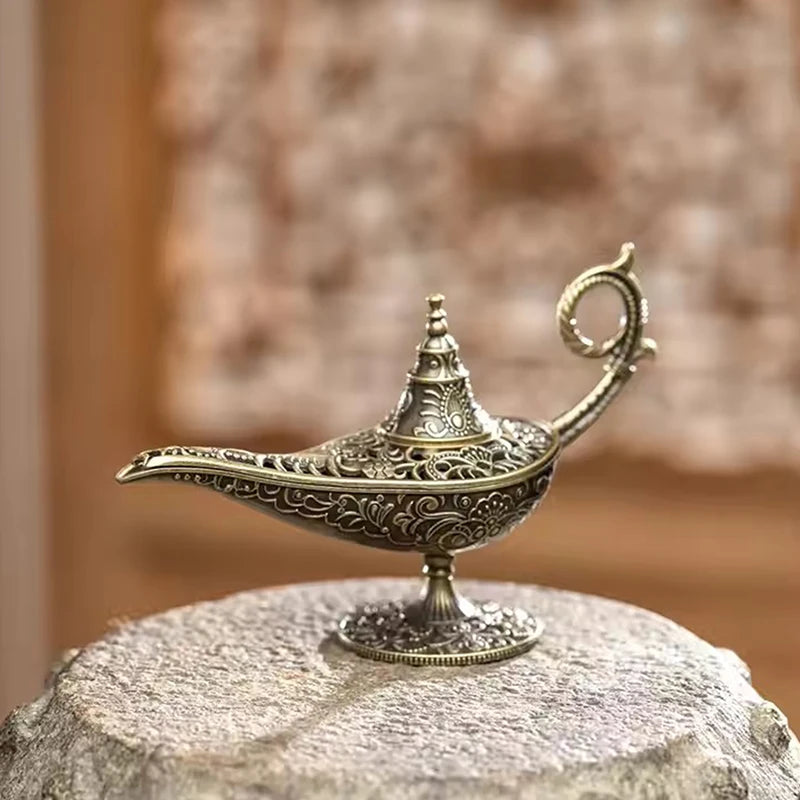 side profile of decorative lamp-shaped metal incense burner on neutral background