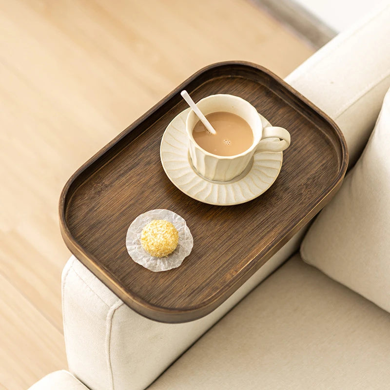 Square walnut bamboo tray clipped to sofa armrest with cup, saucer, and snack