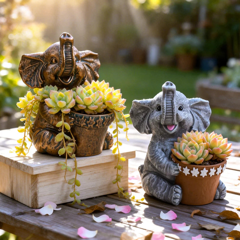 Two elephant succulent planters in gray and bronze resin with small plants, displayed outdoors
