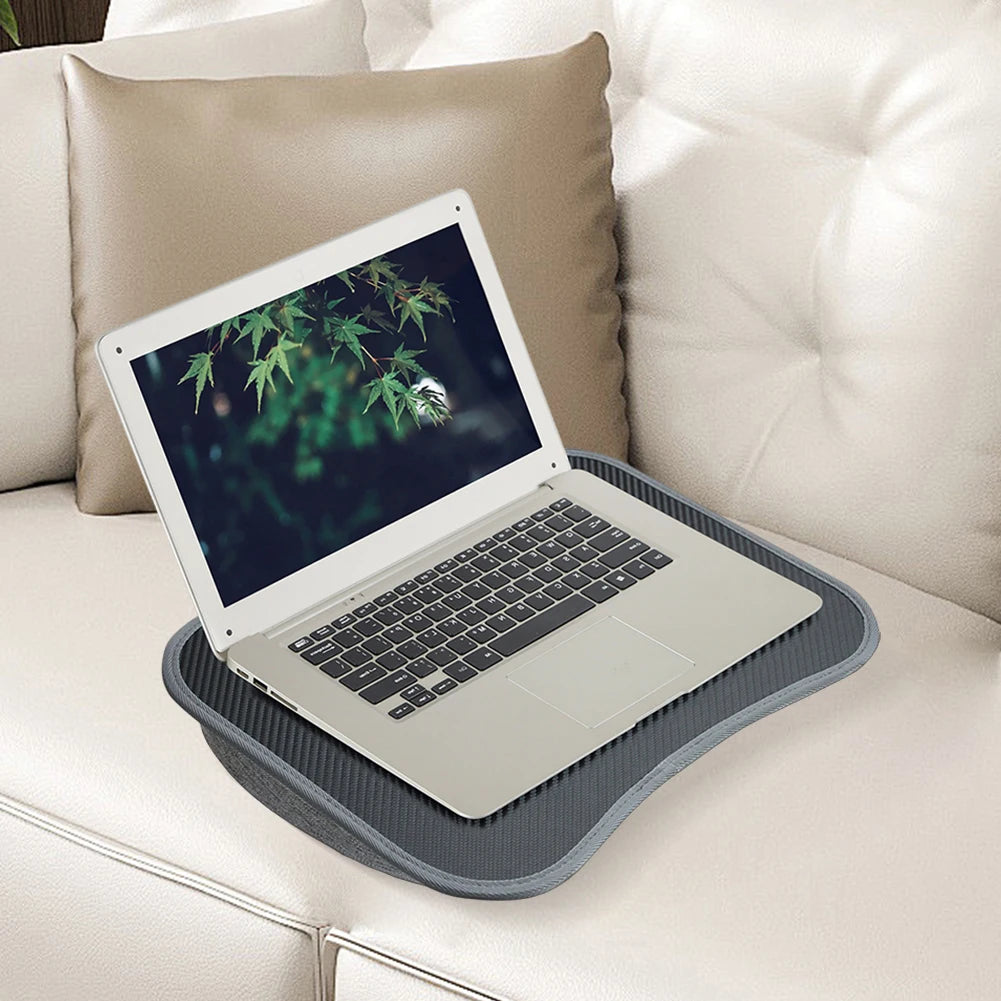 Laptop lap desk on sofa holding an open laptop