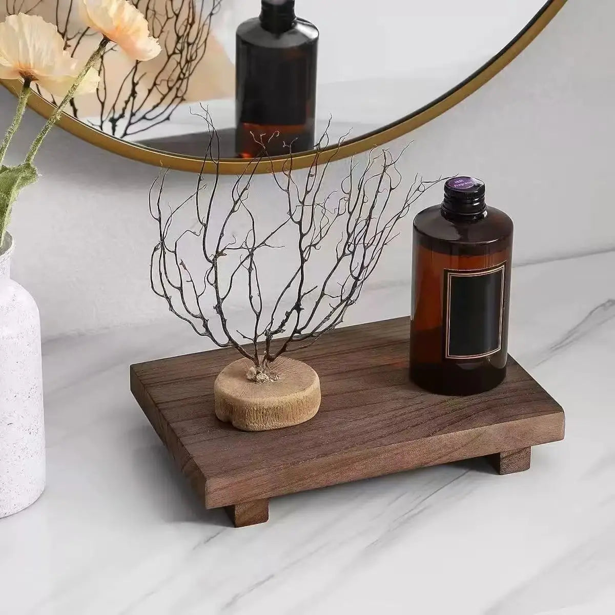 vintage brown wooden decorative tray on bathroom counter with bottle and display branch