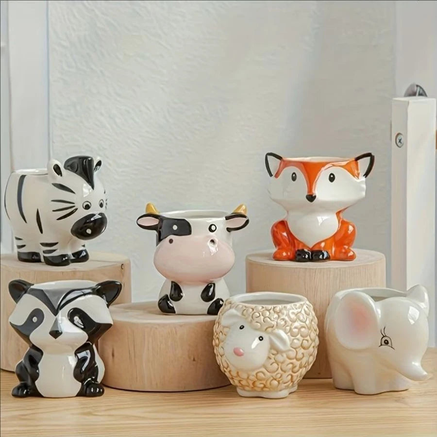 Set of empty animal-shaped cartoon ceramic planters displayed on a tabletop