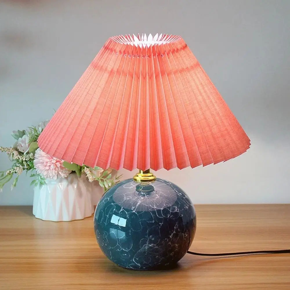 Assorted pleated fabric lampshades in solid and checkered colors arranged in a group