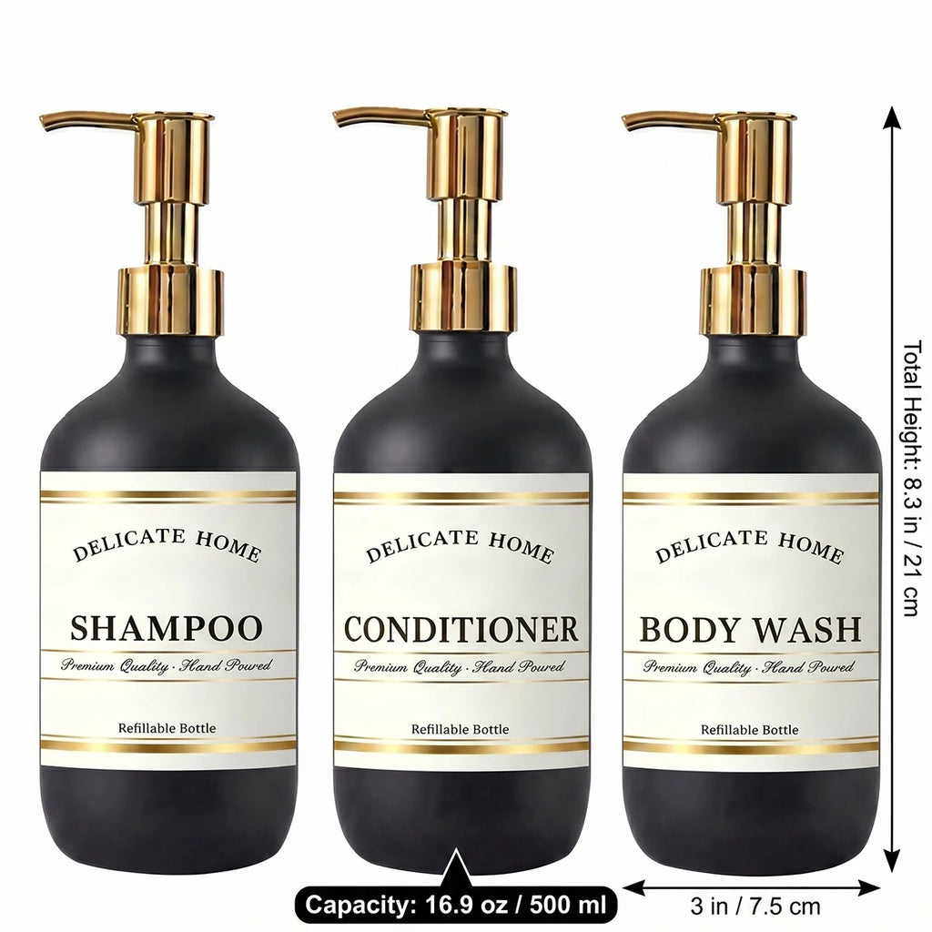 Three matte black 500ml bathroom bottles with gold pumps and labeled for shampoo, conditioner, and body wash, dimensions shown