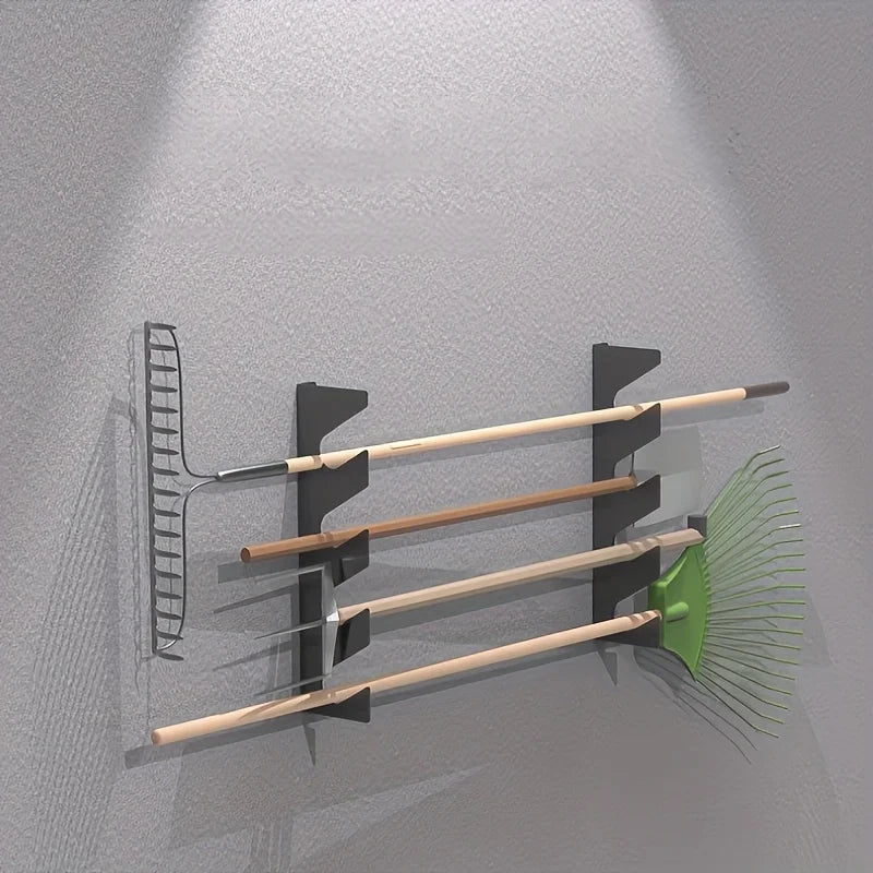Garage wall showing iron rack with long-handled garden tools neatly stored