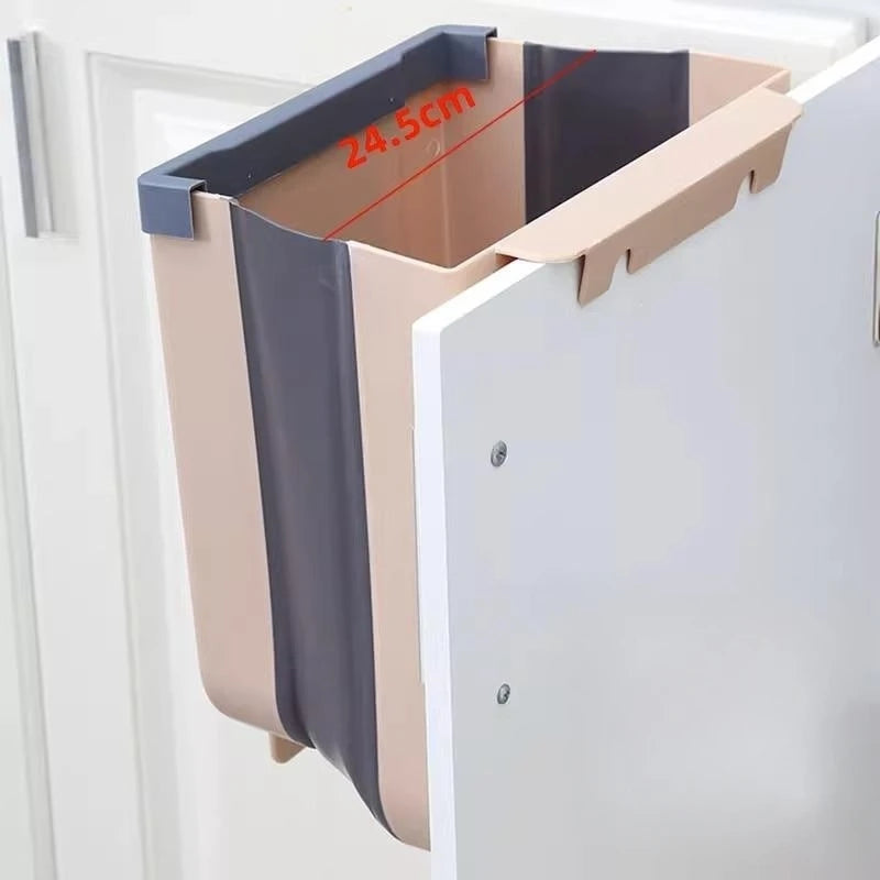 Coffee-colored folding trash bin mounted on a cabinet door with a measuring line showing 24.5cm