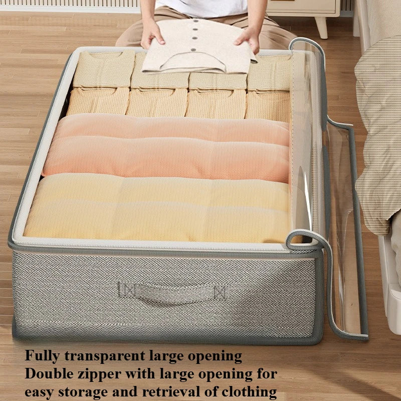 Gray under-bed storage bin filled with folded sweaters, person placing clothes inside