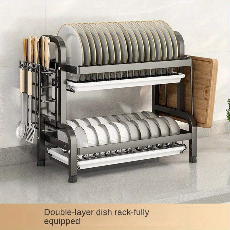 Two-tier dish rack in black finish holding plates, utensils, and board