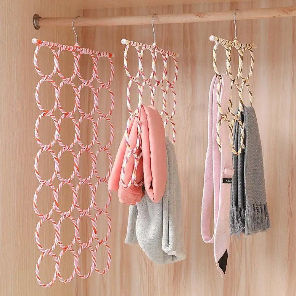 Three rattan weave multi-loop hangers hanging in a closet, each displaying winter scarves and jackets