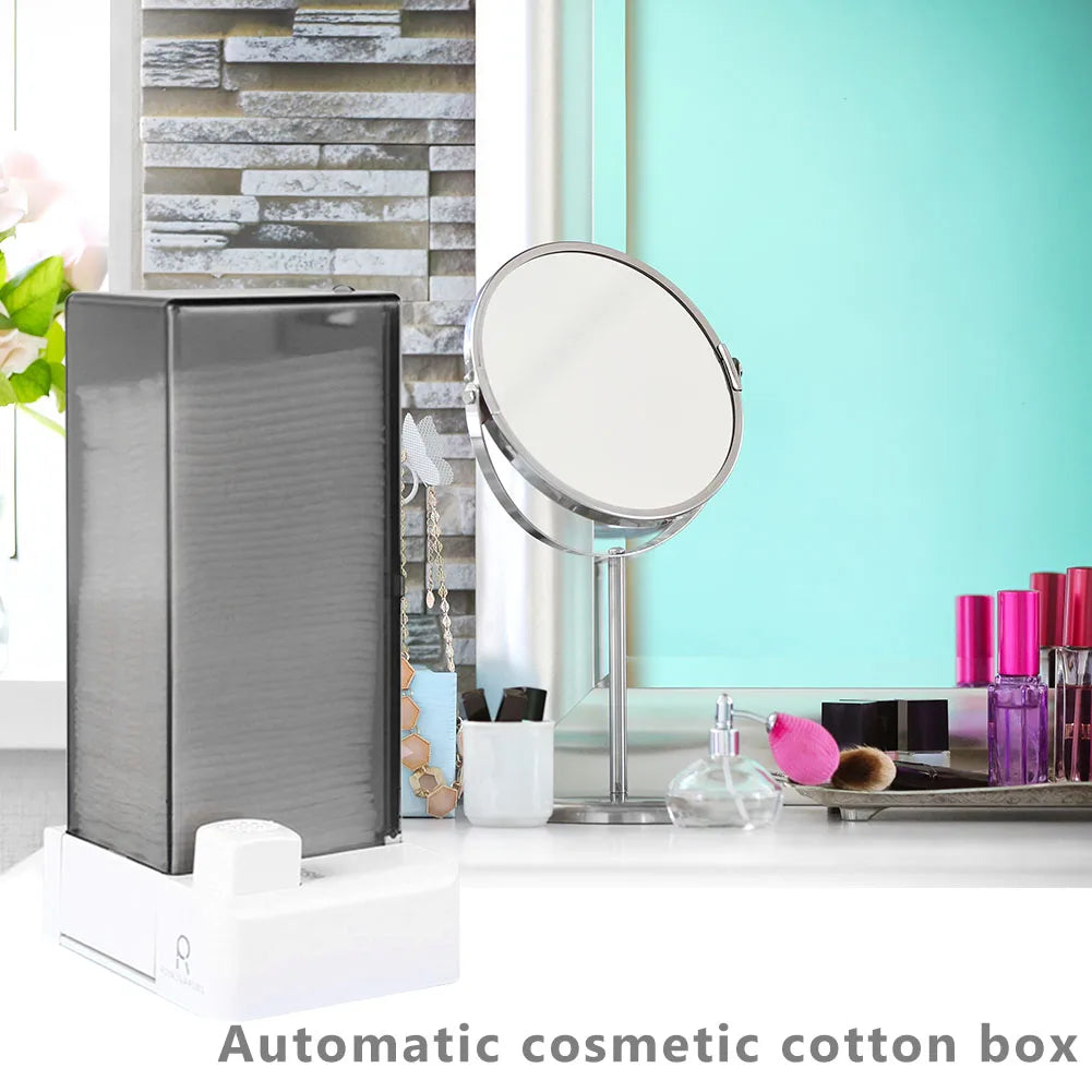 Grey cotton pad dispenser placed on a bathroom vanity with cosmetics and mirror