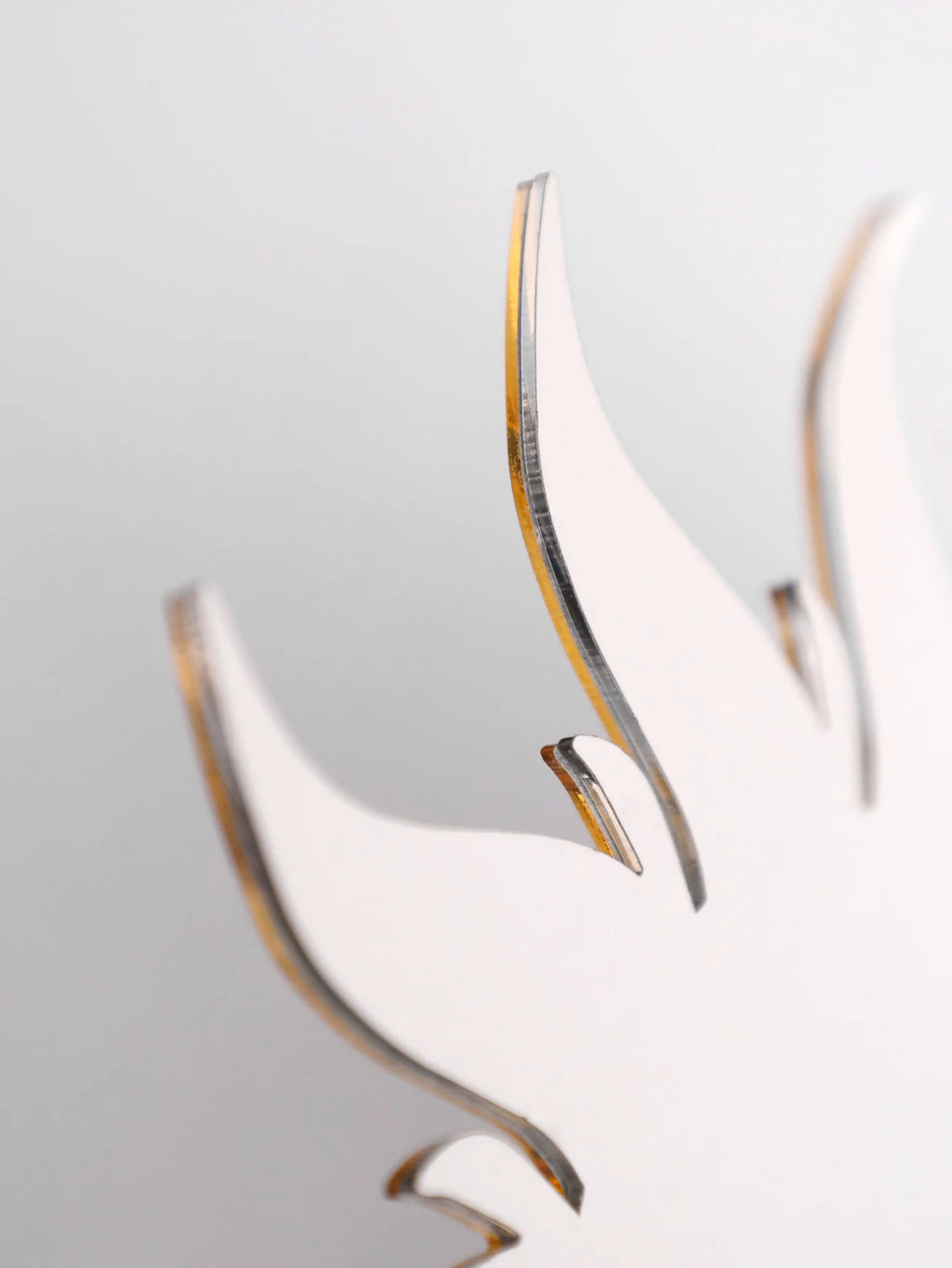 Close-up detail of acrylic sunburst edge showing layered construction