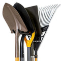 Wall-mounted metal tool hook holding shovels and rakes in a garage or shed