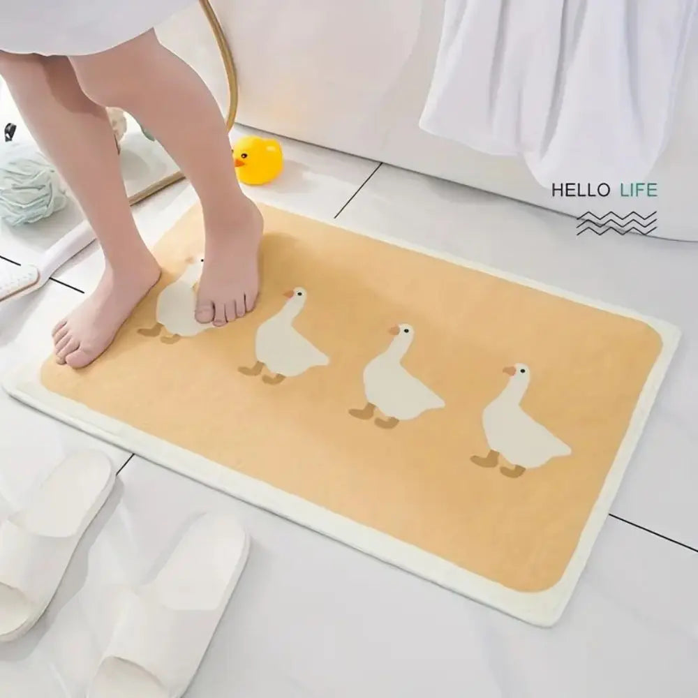 Person stepping out of a shower onto a beige duck motif bath mat, shown on tile floor