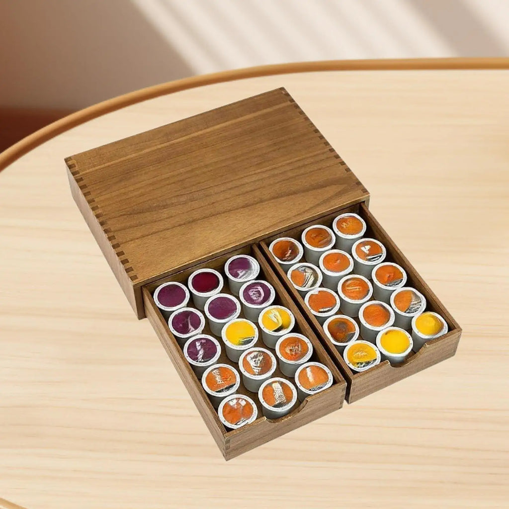 Top-down view of wooden coffee pod organizer drawers open, filled with coffee pods