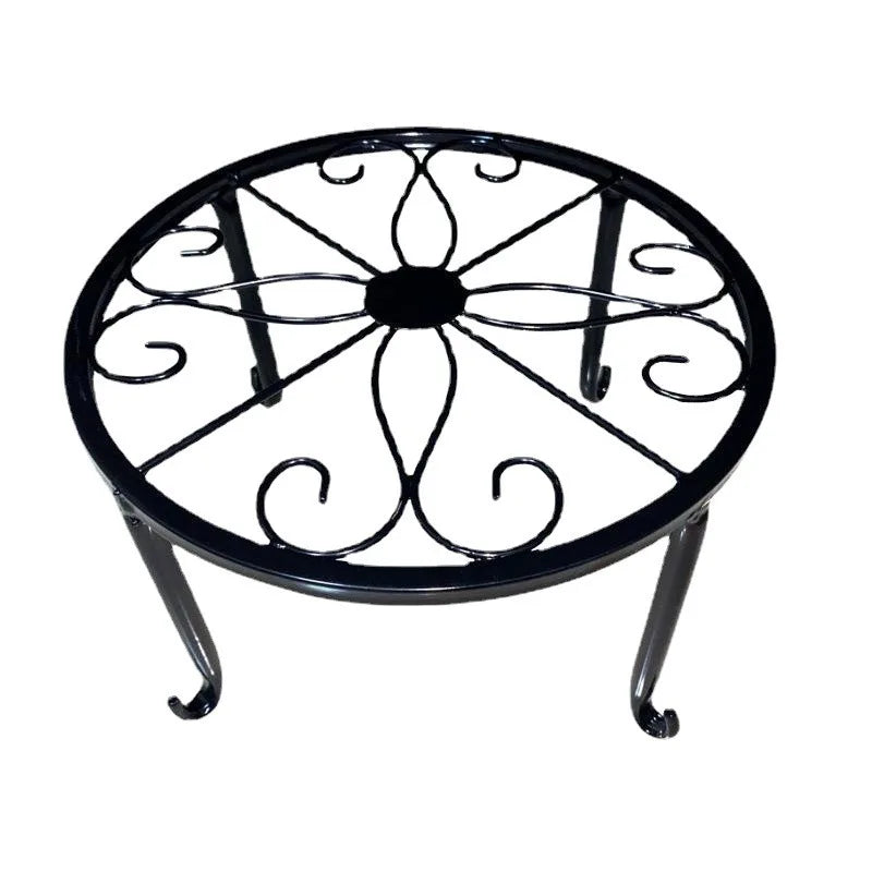 Black round metal plant stand with visible scrollwork from above