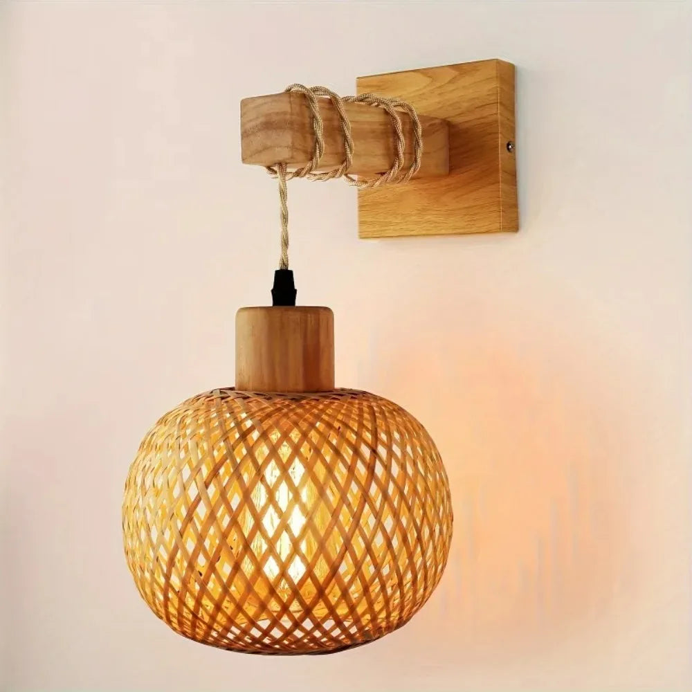 Handwoven bamboo plug-in wall sconce with a natural wood bracket on a white wall