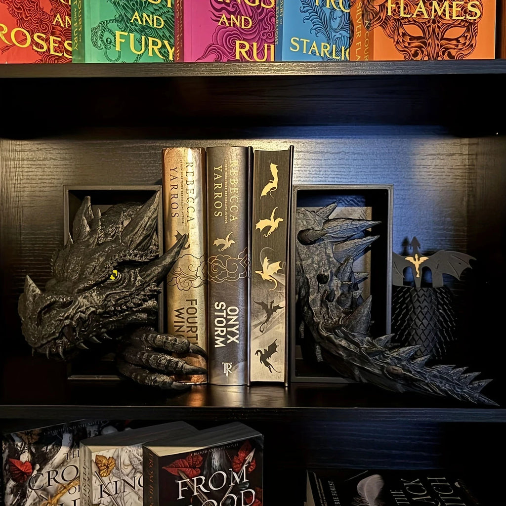 Black dragon resin bookends styled on a dark bookshelf with fantasy novels