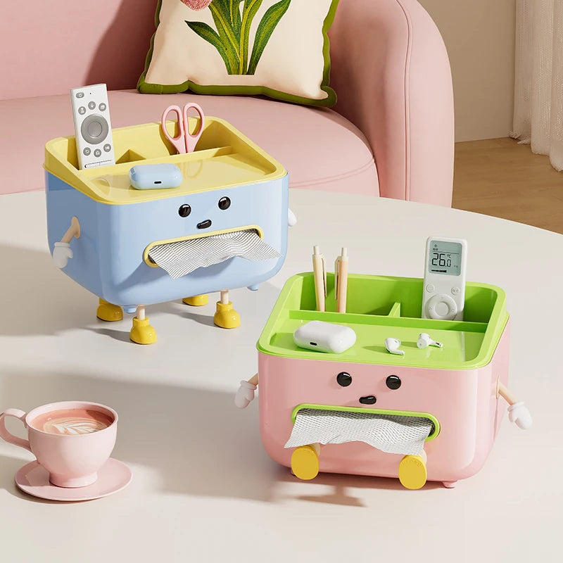 Blue and pink character storage boxes on a table, each with tissue slot and compartment dividers