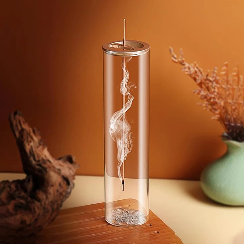 Modern glass incense burner with removable ash catcher in a cozy room setting