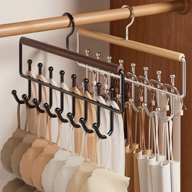 Two organizer racks side by side in a closet, each with ten hooks holding hats and accessories