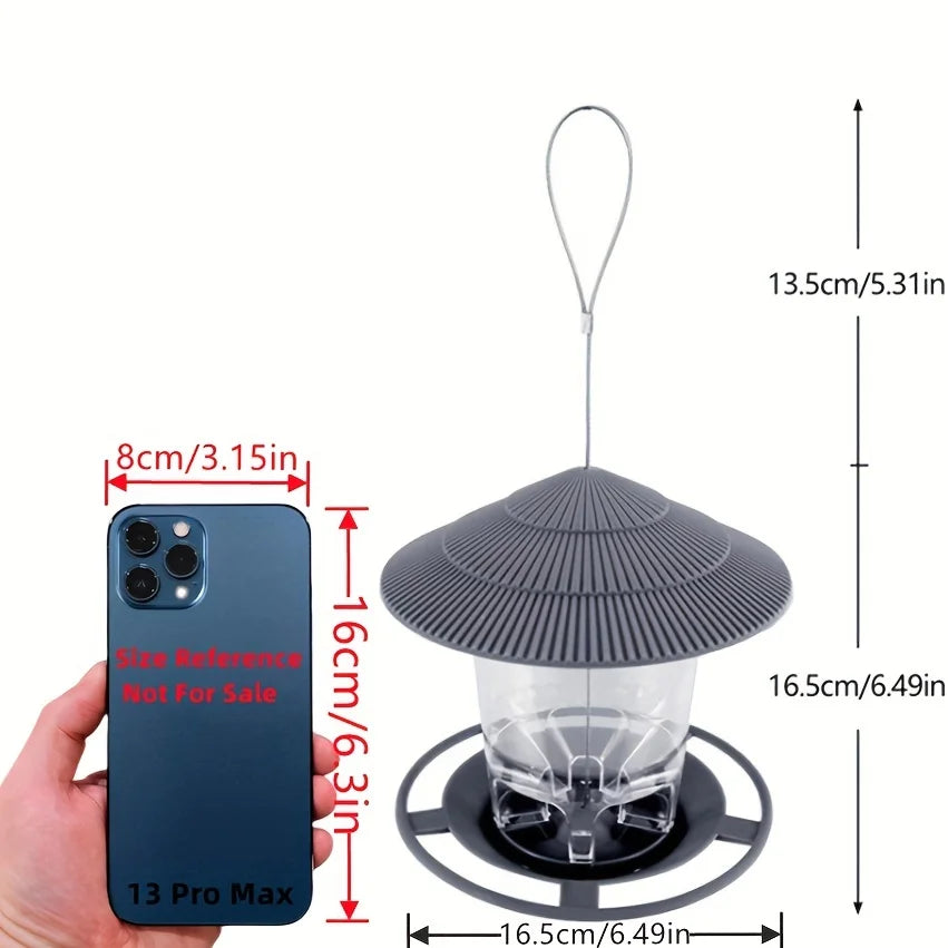 gray hanging bird feeder with labeled size comparison next to a phone