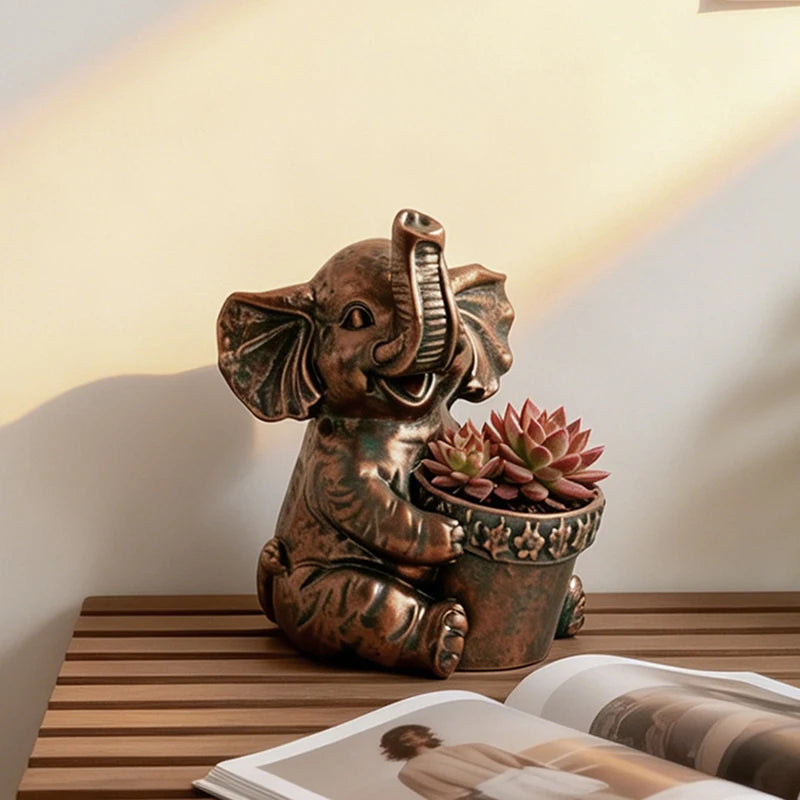 Bronze-style resin elephant planter with succulent, styled on a wooden table