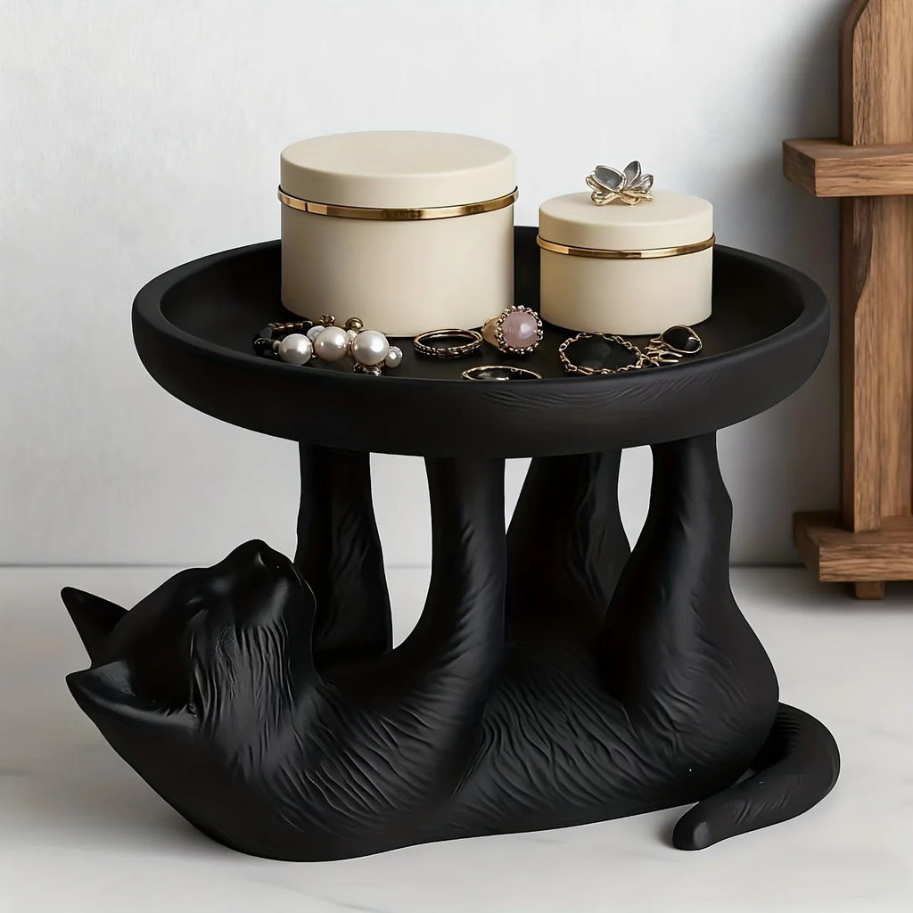 Cat-shaped jewelry tray styled with cream boxes and rings in a bathroom setting