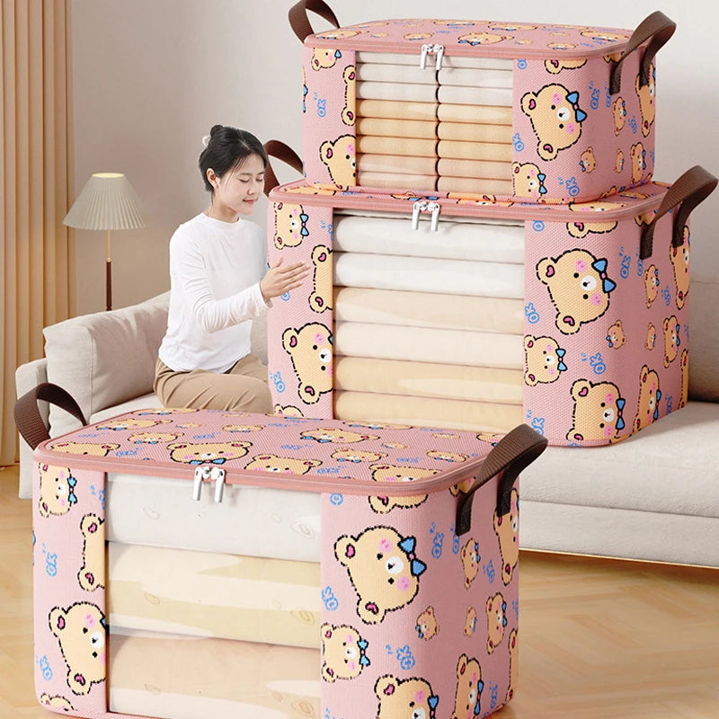 Woman organizing two stacked pink bear print storage bags filled with folded blankets in a living room