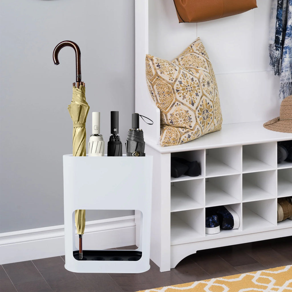 White umbrella stand placed in an entryway, storing four umbrellas