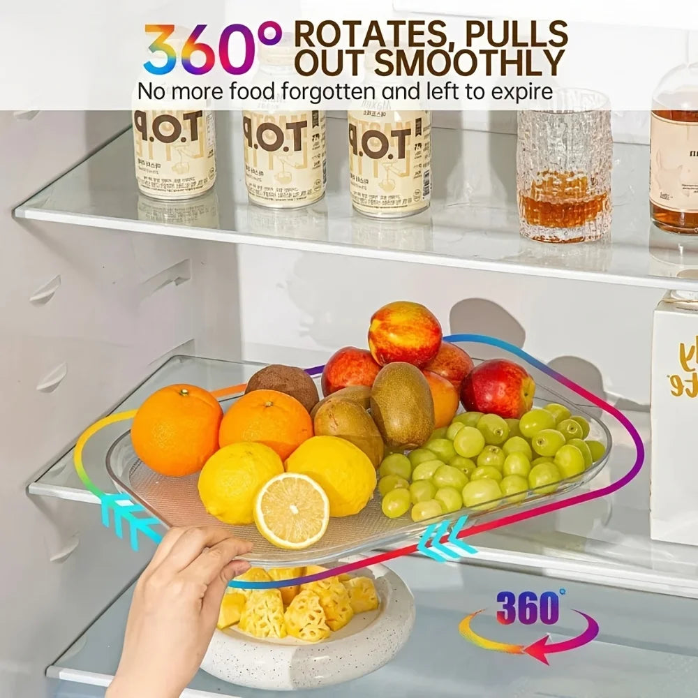 Rectangular clear plastic rotating fridge tray holding fruit on a refrigerator shelf