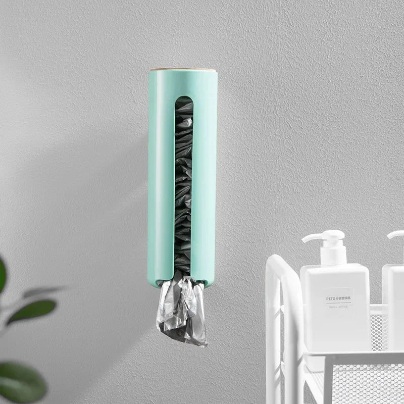 Green wall-mounted plastic bag organizer in bathroom with toiletries