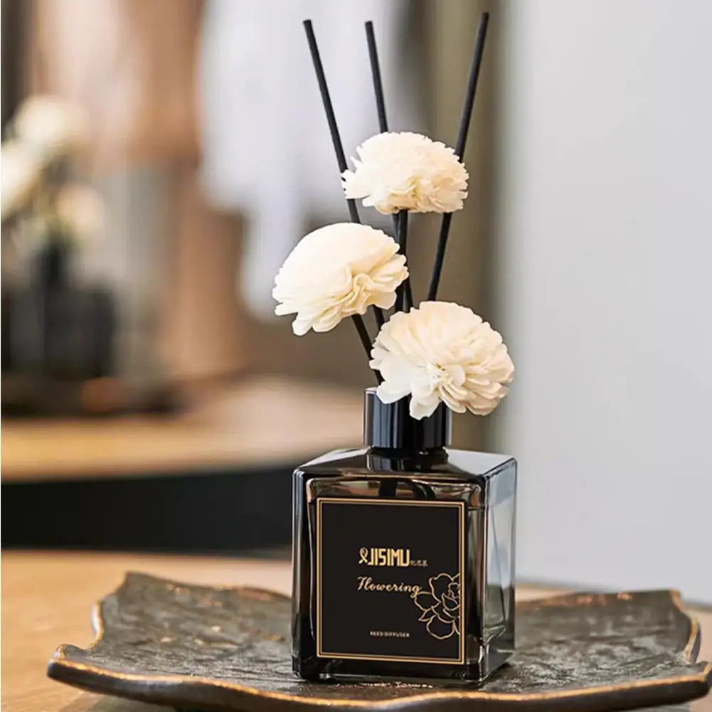 Jasmine reed diffuser with white flower sticks on a display tray in a home setting