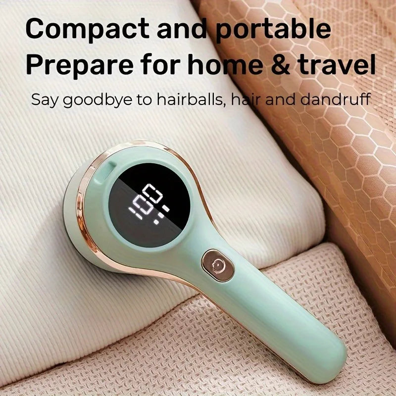 Rechargeable lint remover with digital display resting on folded knits in a cozy home setting
