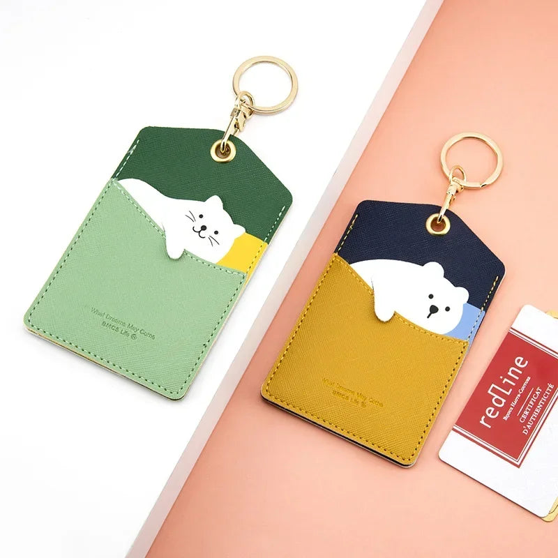 Two animal card holder keychains in green and yellow with cat and bear designs