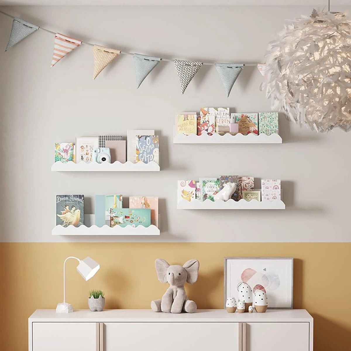 White wavy-edge wall shelves arranged above a cabinet in a modern nursery with books and decor