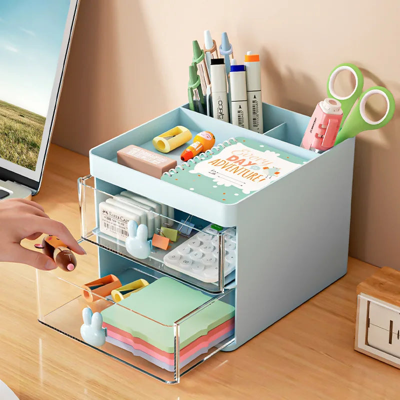 Blue plastic desk organizer with divided top compartments and two clear drawers, shown on a tidy office desk