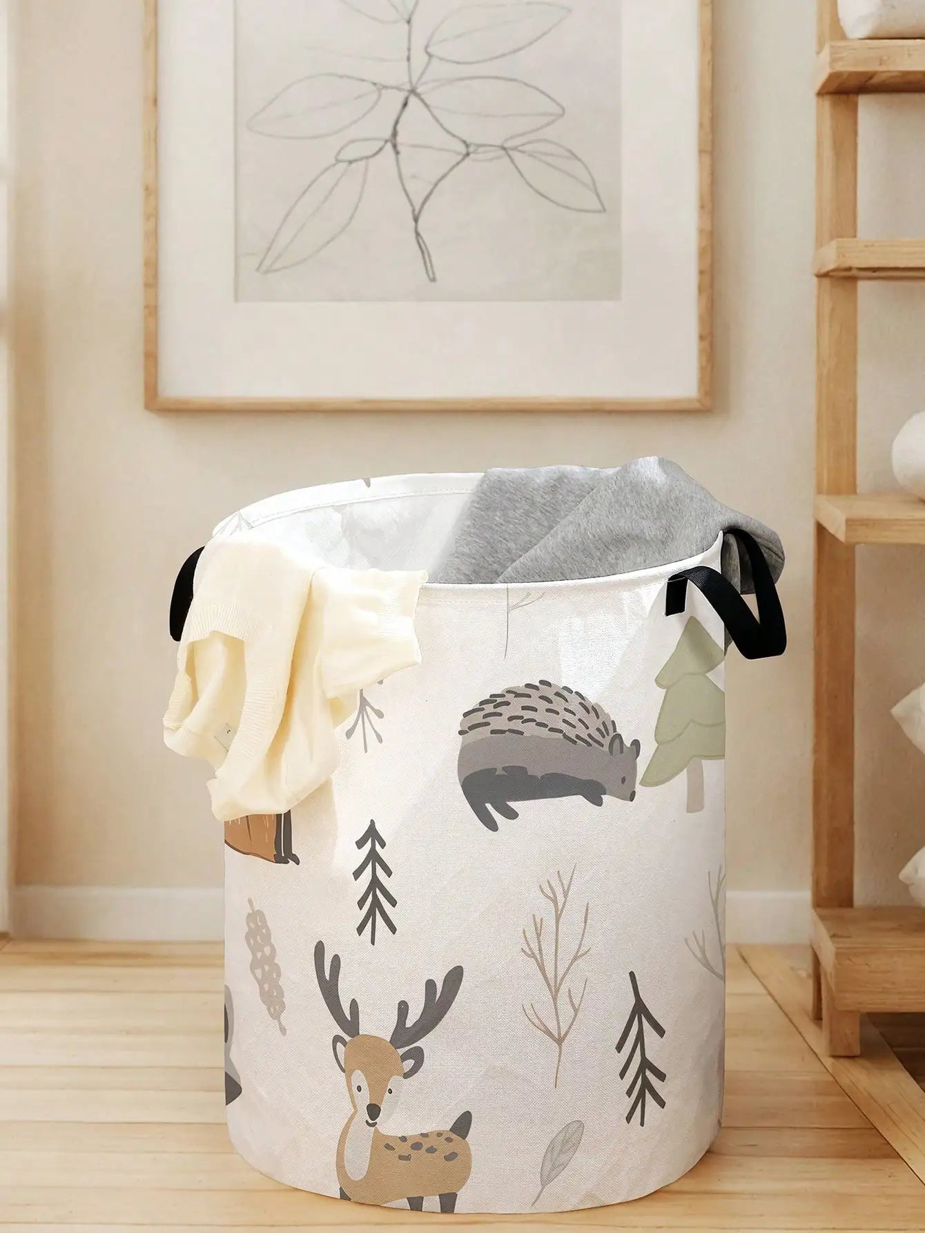 foldable animal canvas laundry basket partially filled with laundry near a shelf