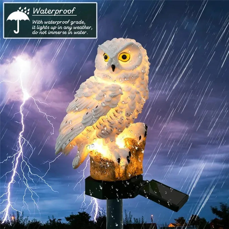 White owl solar garden light illuminated in heavy rain, demonstrating waterproof design