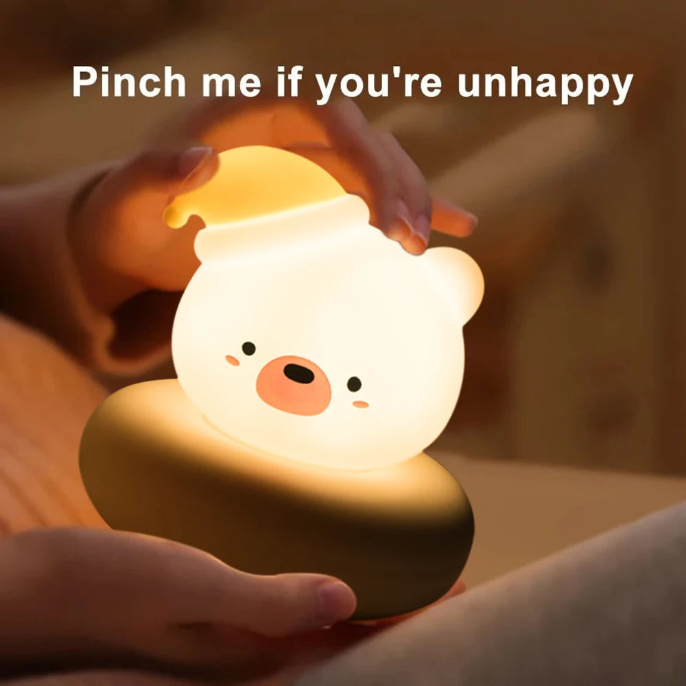 Bear shaped LED night light being gently held in hands