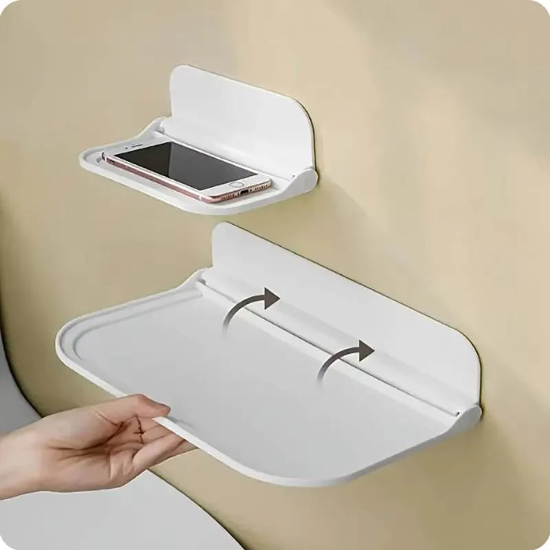 Foldable wall-mounted shelf in small and large sizes, installed on a wall holding a smartphone