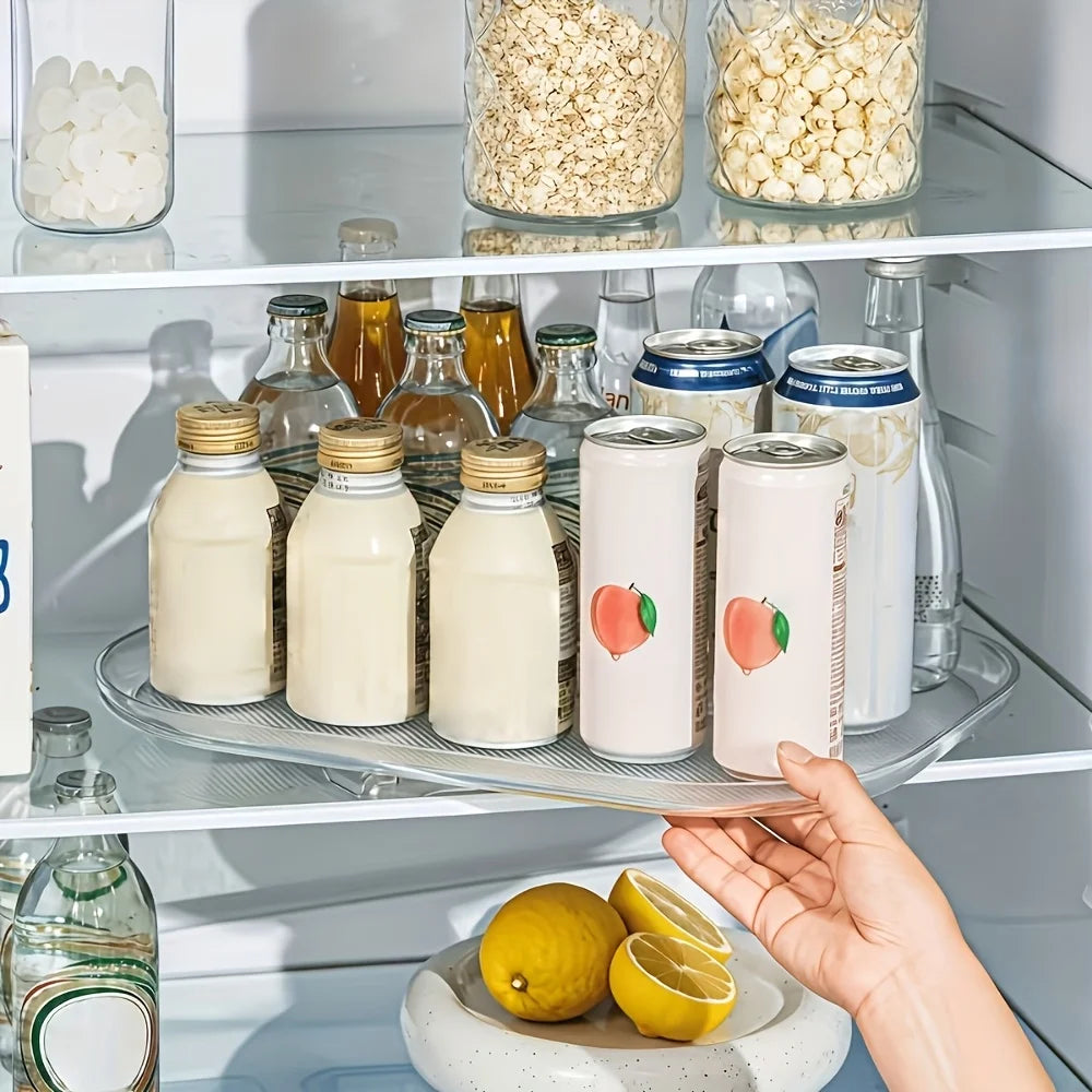 Rectangular turntable organizer in fridge holding various bottles and cans