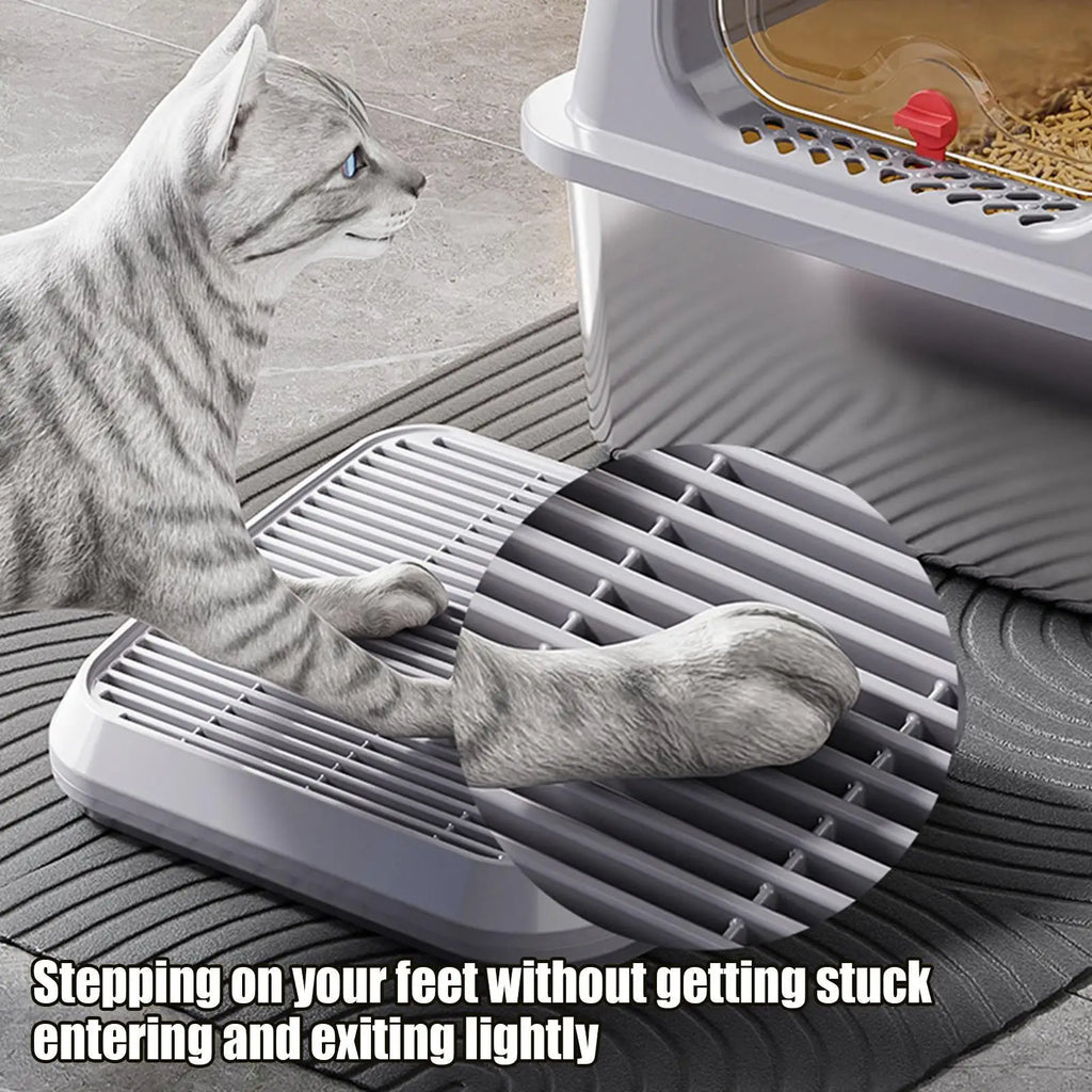 Cat stepping lightly on grid surface of litter catcher ramp, detail of paw-friendly design
