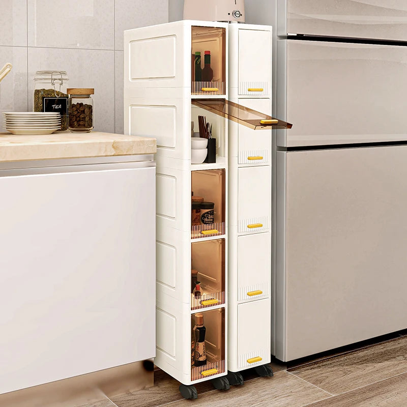 White slim rolling storage cabinets shown with flip-up transparent doors open, positioned by a kitchen counter