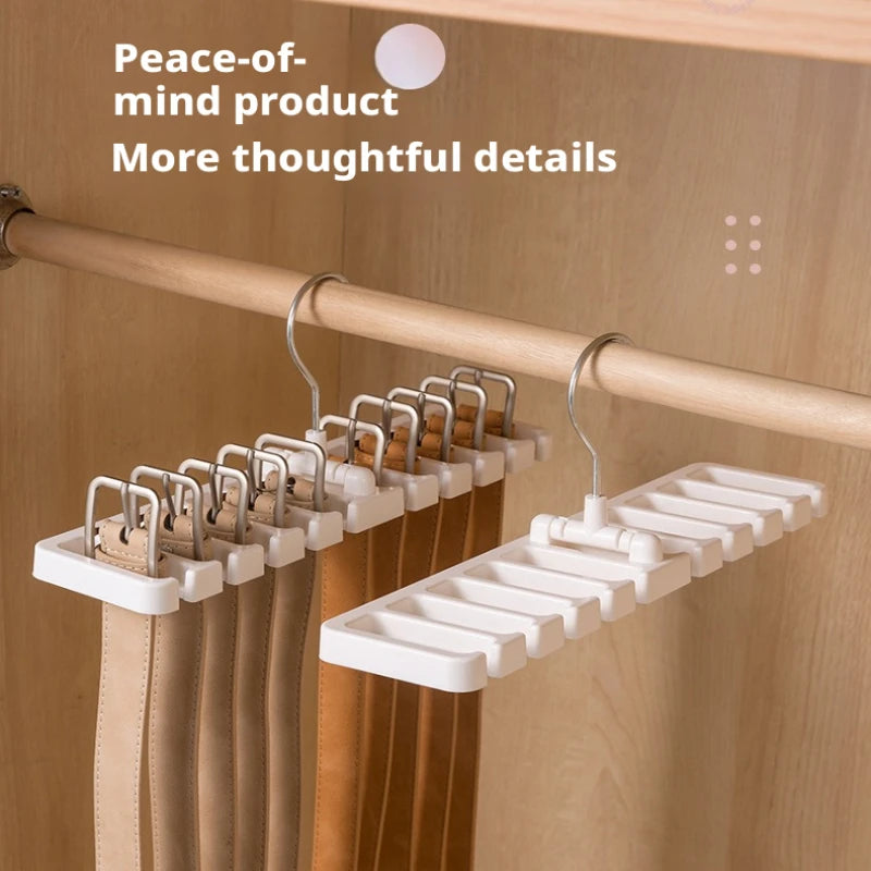 White rotating accessory hangers on a closet rod with belts; text overlay present